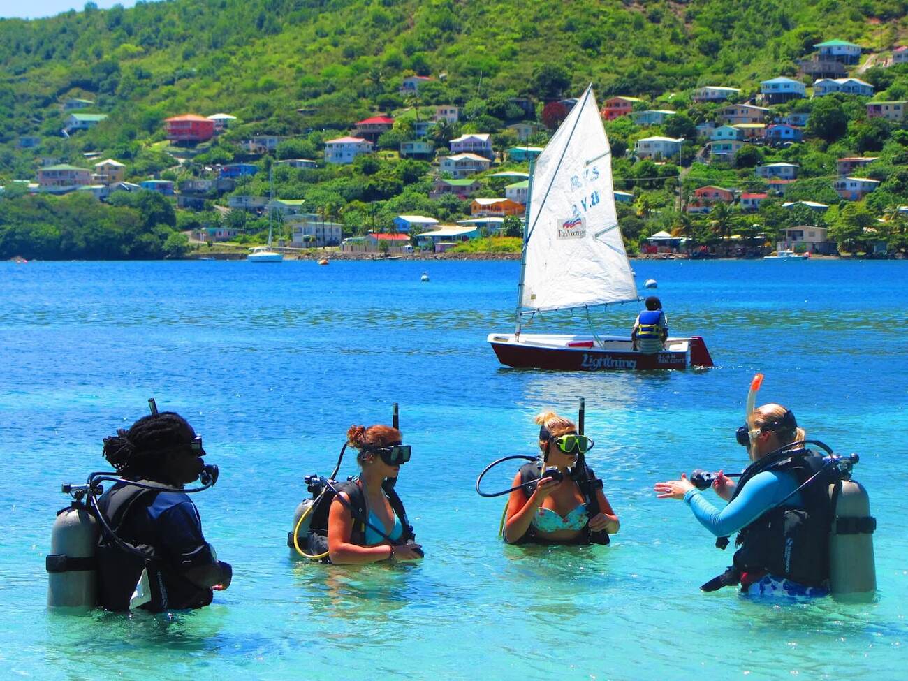 A PADI instructor guiding students through a shallow-water scuba lesson in Admiralty Bay, Bequia